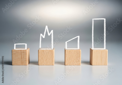Abstract graph charts drawn with chalk on small wooden blocks illustrating different market trends.