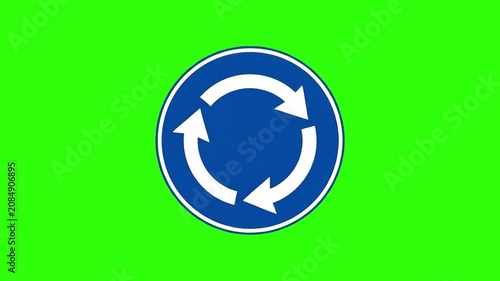 A circular blue traffic sign featuring white directional arrows indicating a roundabout, set against a green screen background. This graphic is perfect for driving lessons, urban planning presentation