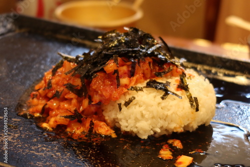 Traditional Korean barbecue featuring grilled marinated meats, fresh side dishes, and a tabletop grill. Warm, inviting dining scene showcasing authentic Korean cuisine and shared meals.