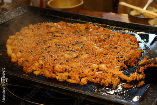 Traditional Korean barbecue featuring grilled marinated meats, fresh side dishes, and a tabletop grill. Warm, inviting dining scene showcasing authentic Korean cuisine and shared meals.