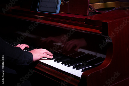 Sticker Close-up details of jazz instruments and musicians performing on stage under dramatic blue and purple concert lighting, featuring saxophone, piano, drumsticks and live music atmosphere