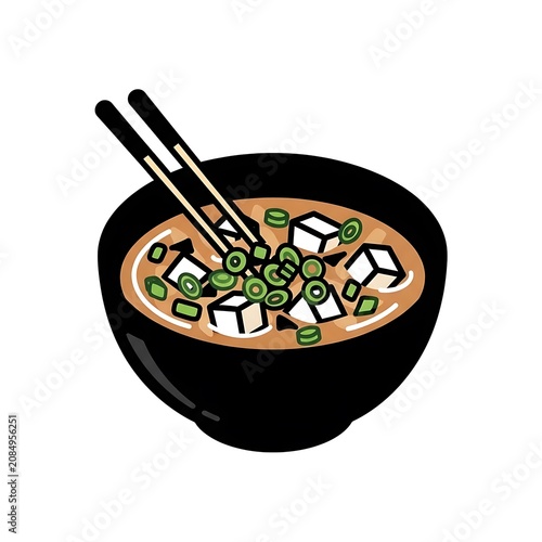 Black bowl with wooden spoon and ginger root.