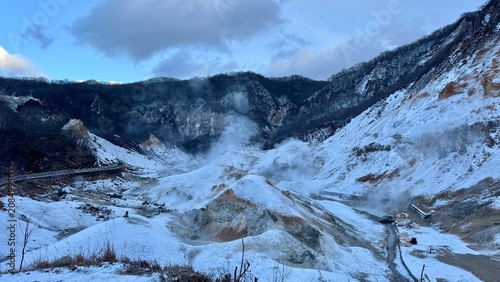 Tableau sur toile Snow covered volcanic valley beneath a rugged mountain ridge