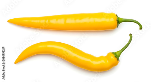 Two yellow chili peppers on white background food ingredient