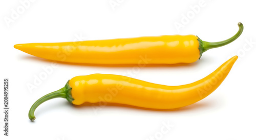 Two yellow chili peppers on white background food