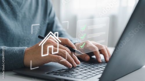 Bild auf Leinwand Person using laptop and stylus with digital smart home checklist interface for o