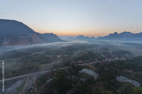 aerial view of morning fog over the village in laos