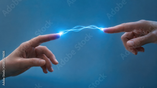 Two hands reaching toward each other with electric blue lightning arc between fingertips on dark blue background, conceptual energy connection