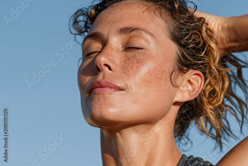 Serene sunlit woman face sunlit skin freckled skin closed eyes relaxed expression outdoor portrait