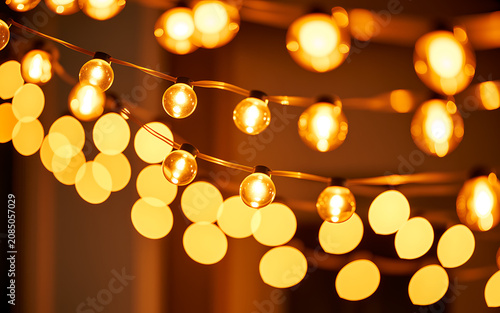 String of warm yellow christmas lights, glowing bulbs on copper wire string lights yellow lights warm lighting