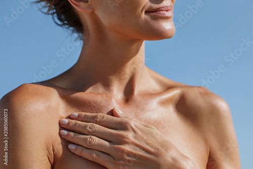 Sunlit skin collarbone close up touching collarbone serene woman chest shoulder natural light