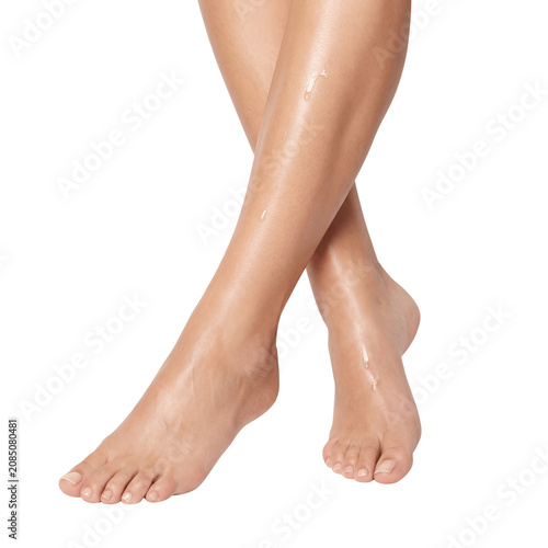 Smooth female legs and moisturized feet with oil drops on a transparent background