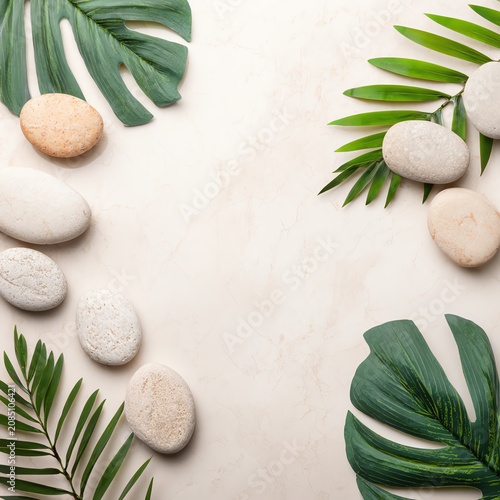 Tropical leaves and smooth stones arrangement.