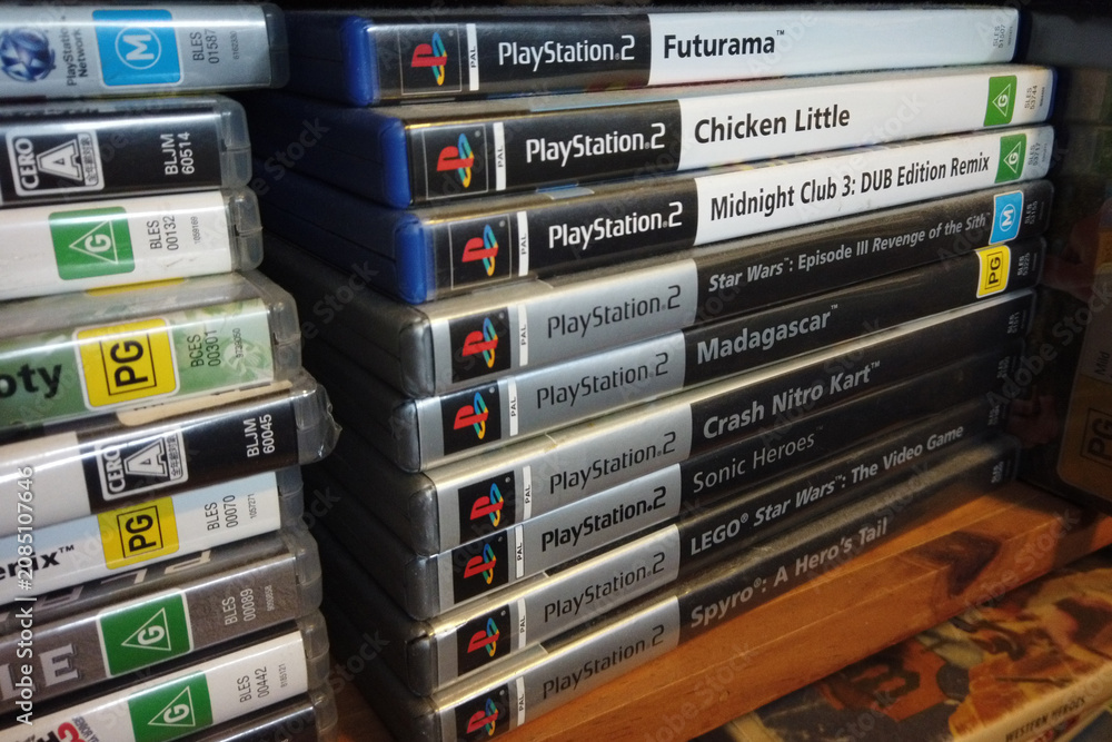 Fototapeta premium North Haven, South Australia - July 5 2026: Stack of PlayStation 2 video game cases on a shelf