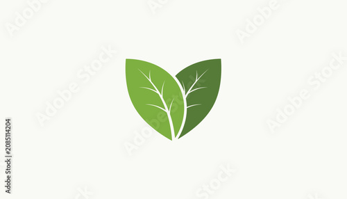 Two vibrant fresh green leaves arranged carefully to form a heart shape against a soft off-white background.