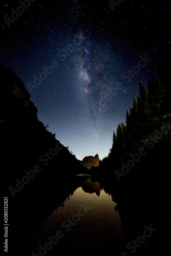 The Milky Way rises between two mountains above the Thap Put mine in Phang Nga Province, Thailand.