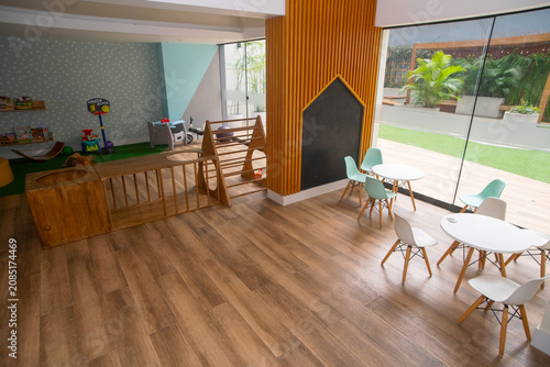 Fotografía Modern colorful children playroom with wooden furniture, small tables, and indoo