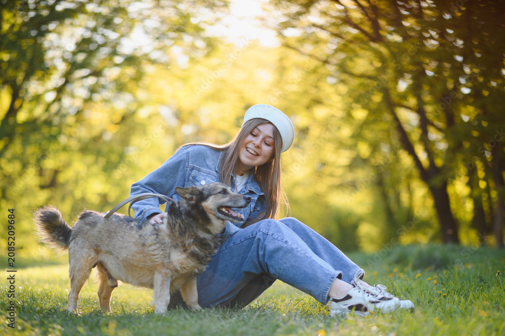 Fototapeta premium Young woman enjoying summer day with her dog