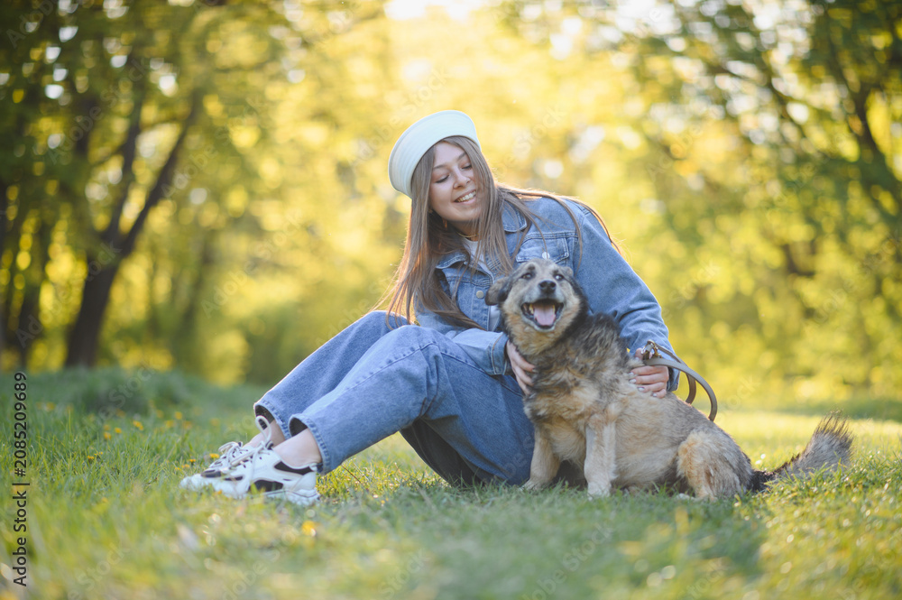 Fototapeta premium Young girl enjoying summer day with happy dog