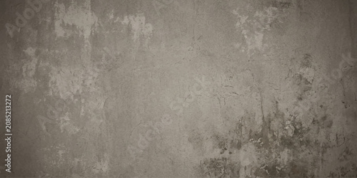 Photos A textured and weathered concrete wall, showcasing subtle imperfections and a rustic, industrial aesthetic, with a muted gray tone creating a sense of depth and character