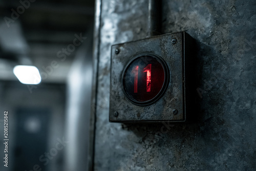 Vintage Elevator Floor Indicator Displaying Number Eleven in Cinematic Close Up