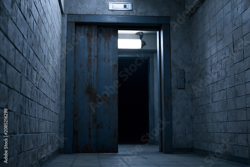 Old Rusted Elevator with Mysterious Figure Peeking from Inside in Psychological Horror Scene