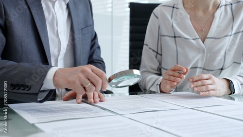 Fotografía Business professionals reviewing legal contracts and important documents with a