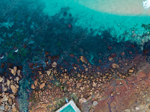 Aerial view of rocky beach shore.