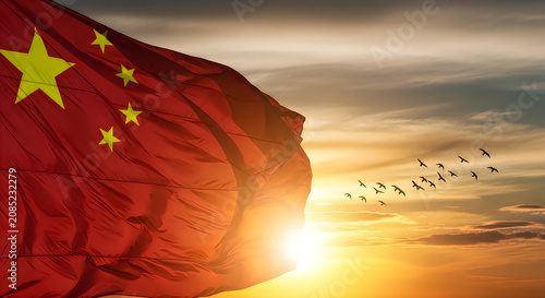 Silhouette of Flag Waving at Sunrise with Dramatic Sky and Flying Birds