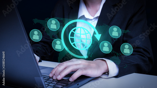 Global Connection and Networking: A person in business attire uses a laptop to connect with a global network of people, represented by illuminated icons on a digital world map.