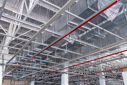 Exposed ceiling with HVAC ducts and fire sprinkler pipes