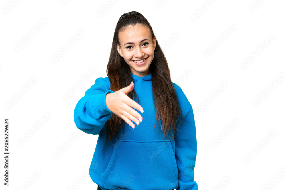 Fototapeta premium Young Arabian woman over isolated chroma key background shaking hands for closing a good deal