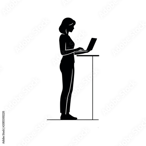 Businesswoman using laptop at standing desk silhouette