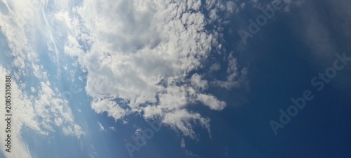 Bild auf Leinwand Beautiful altocumulus and cumulus clouds in a bright blue sky on a sunny day
