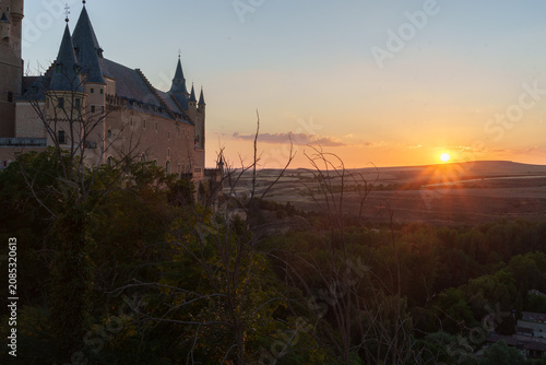 Alcazar of segovia castle at sunset, historic spanish fortress architecture overlooking golden rural landscape