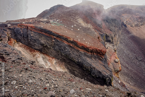 The rugged rim of Mount Fuji's summit crater reveals layered volcanic rock