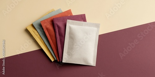 Colorful sachet packets on dual background