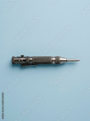 Professional automatic metal center punch tool on light blue background