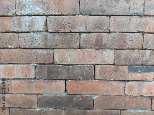 Close up of rustic exposed red brick wall texture background