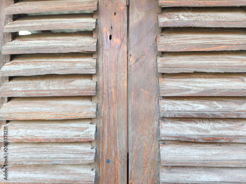 Close up of vintage rustic wooden louvered window shutter background