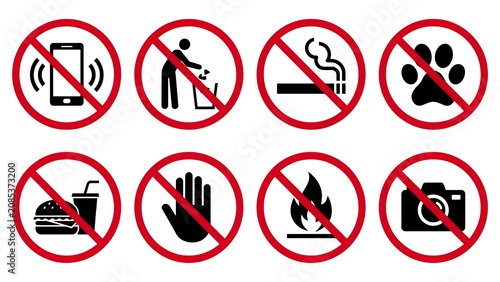 A collection of warning signs prohibiting actions and items on display