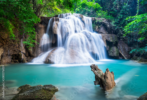 Tiered tropical waterfall with turquoise pool and lush green surroundings waterfall turquoise tropical landscape