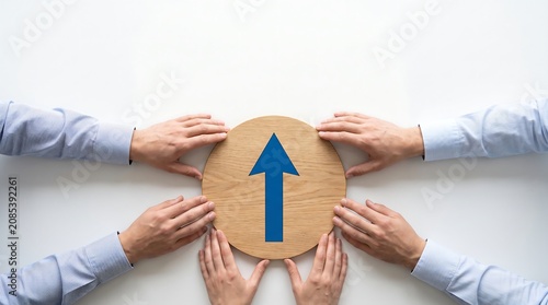 Business Teamwork Concept with Upward Arrow on Wood Disc