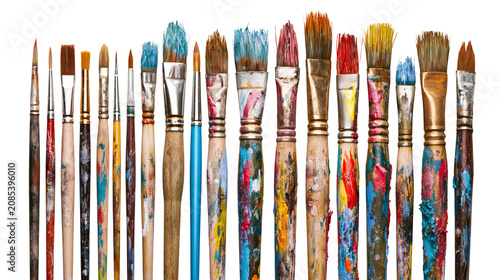 Принти на полотні Assortment of used paint brushes with colorful paint splatters on handles