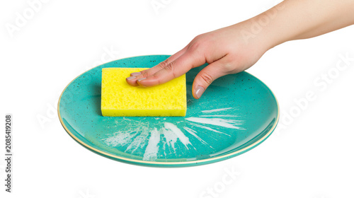 фотографія Hand cleaning turquoise plate with yellow sponge and soap suds