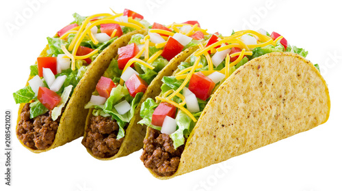 Tableau sur toile Three crunchy tacos with ground beef lettuce tomato onion, and cheese
