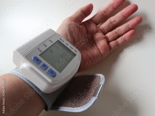 Quadro su tela Digital wrist blood pressure monitor measuring high blood pressure at home for h