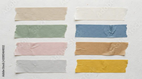 Assorted Washi Tapes: A collection of eight strips of washi tape in various pastel colors and textures, neatly arranged in two columns on a textured surface.