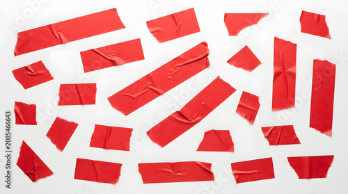 Red Tapes on White: A collection of red adhesive tapes scattered across a bright white surface, showcasing their texture and ability to stick and seal.