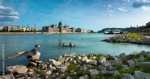 Budapest city skyline time lapse with Hungarian Parliament Building across Danube river, rushing clouds and moving shadows over city landmark